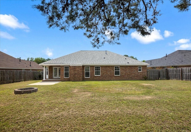 2071 Lake Forest Dr, Grovetown, GA 30813 - back of house with a fire pit, a fenced backyard, brick siding, and a patio