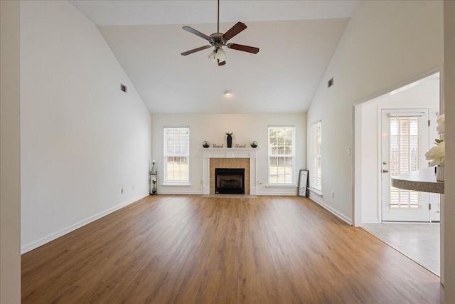2071 Lake Forest Dr, Grovetown, GA 30813 - unfurnished living room with high vaulted ceiling, a ceiling fan, wood finished floors, and a tiled fireplace