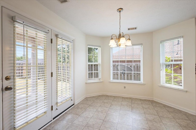 2071 Lake Forest Dr, Grovetown, GA 30813 - unfurnished dining area with a chandelier, plenty of natural light, and light tile patterned flooring