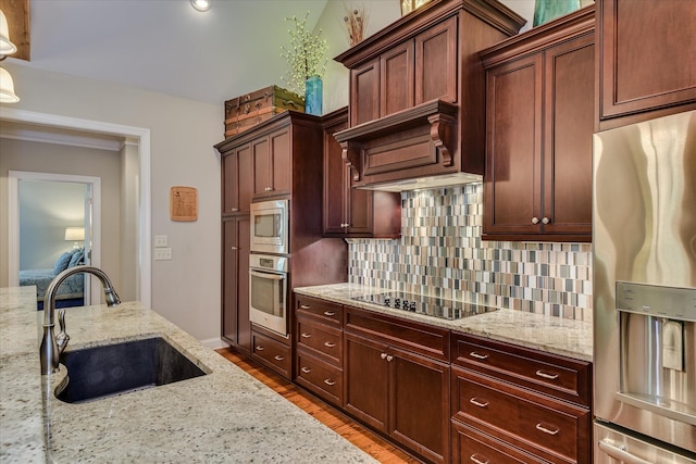 203 Jacque Cir, Mccormick, SC 29835 - kitchen featuring a sink, appliances with stainless steel finishes, decorative backsplash, wood finished floors, and light stone countertops