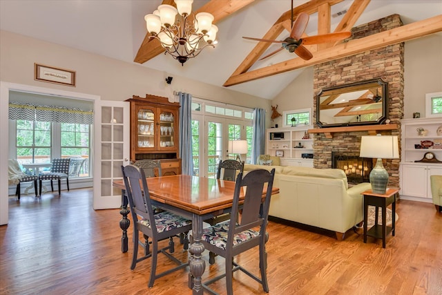 203 Jacque Cir, Mccormick, SC 29835 - dining room featuring beamed ceiling, french doors, a fireplace, a chandelier, and light wood-style flooring