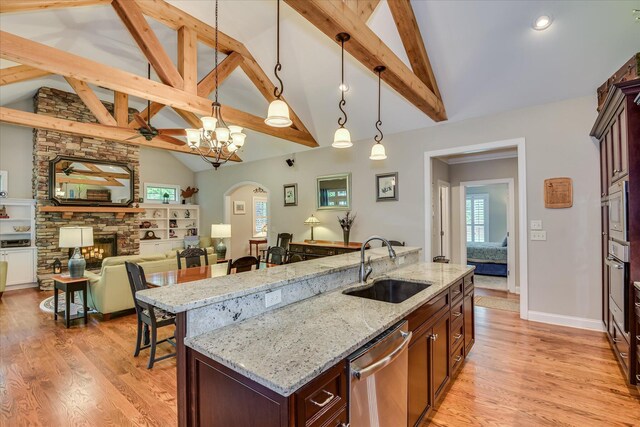 203 Jacque Cir, Mccormick, SC 29835 - kitchen with stainless steel appliances, a sink, hanging light fixtures, light wood-style floors, and beam ceiling