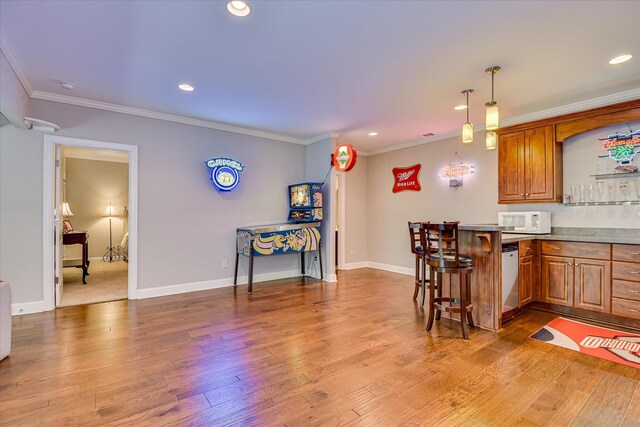 203 Jacque Cir, Mccormick, SC 29835 - kitchen with white appliances, brown cabinetry, light wood-style flooring, recessed lighting, and a breakfast bar