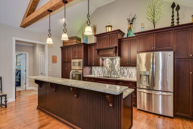 203 Jacque Cir, Mccormick, SC 29835 - kitchen featuring appliances with stainless steel finishes, a kitchen breakfast bar, tasteful backsplash, light wood-type flooring, and decorative light fixtures