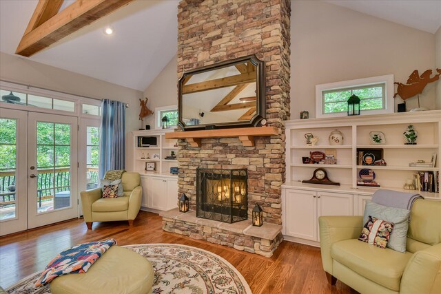 203 Jacque Cir, Mccormick, SC 29835 - living area featuring high vaulted ceiling, a fireplace, french doors, and wood finished floors