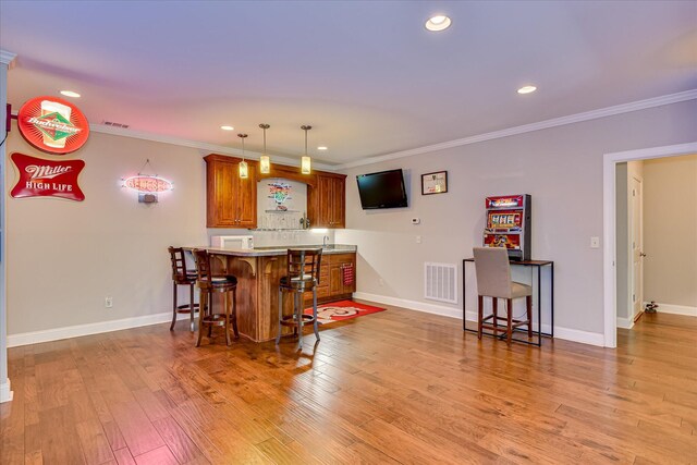 203 Jacque Cir, Mccormick, SC 29835 - indoor wet bar featuring crown molding, recessed lighting, light wood-type flooring, baseboards, and pendant lighting