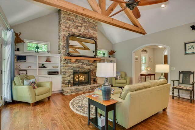 203 Jacque Cir, Mccormick, SC 29835 - living area with beam ceiling, arched walkways, a fireplace, healthy amount of natural light, and ceiling fan