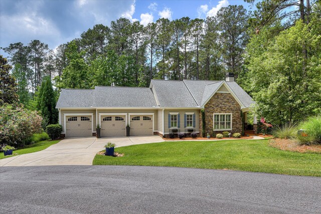 203 Jacque Cir, Mccormick, SC 29835 - view of front of property with a garage, driveway, stone siding, a front yard, and a chimney