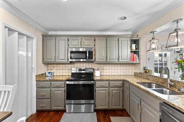 kitchen with a sink, gray cabinetry, dark wood-style flooring, and stainless steel appliances