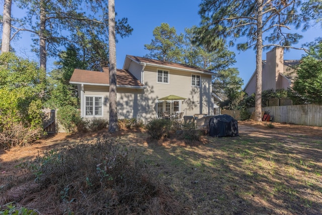 rear view of property featuring fence