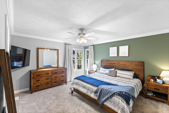 carpeted bedroom featuring baseboards, a textured ceiling, ceiling fan, and crown molding