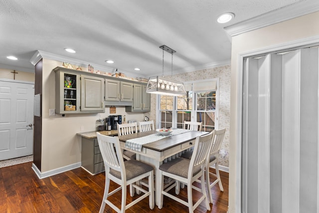 dining space featuring crown molding, baseboards, and dark wood-style flooring