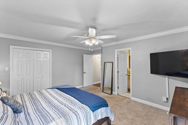 bedroom featuring light colored carpet, baseboards, a closet, and ornamental molding