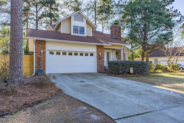 view of front of house with concrete driveway, fence, brick siding, and a chimney