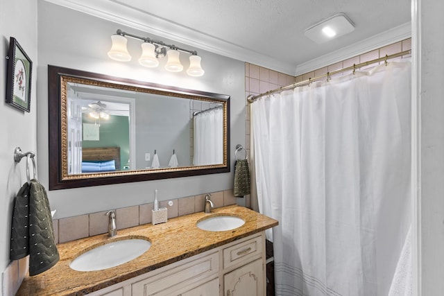 bathroom featuring a sink, a shower with curtain, ornamental molding, and double vanity