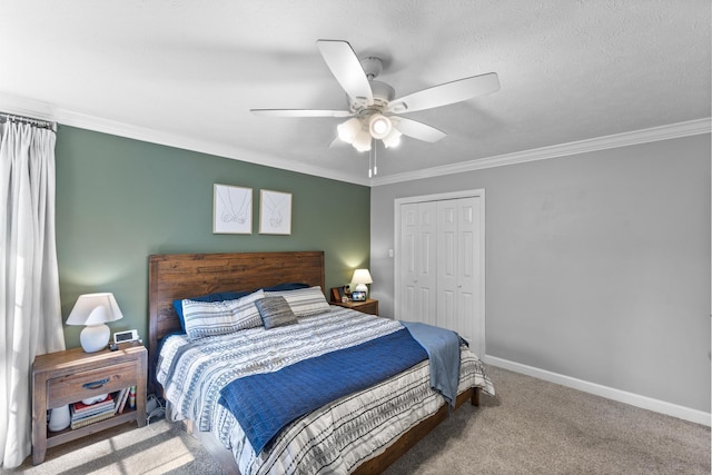 bedroom featuring carpet, baseboards, ceiling fan, a closet, and crown molding