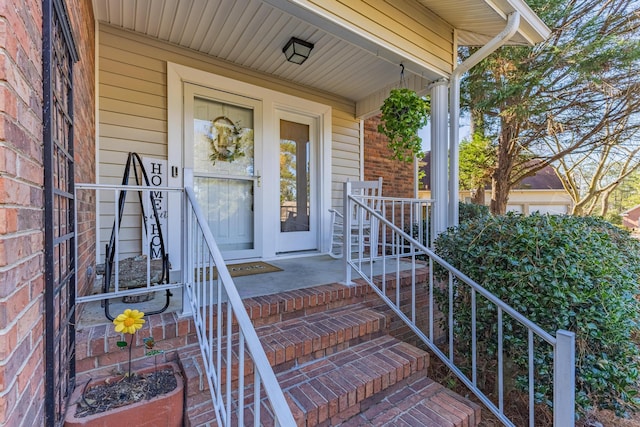 property entrance with brick siding and covered porch