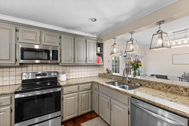 kitchen featuring gray cabinetry, ornamental molding, decorative backsplash, appliances with stainless steel finishes, and a sink