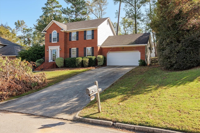 colonial-style house featuring a front yard and a garage