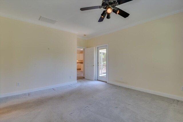 carpeted empty room with ceiling fan and crown molding