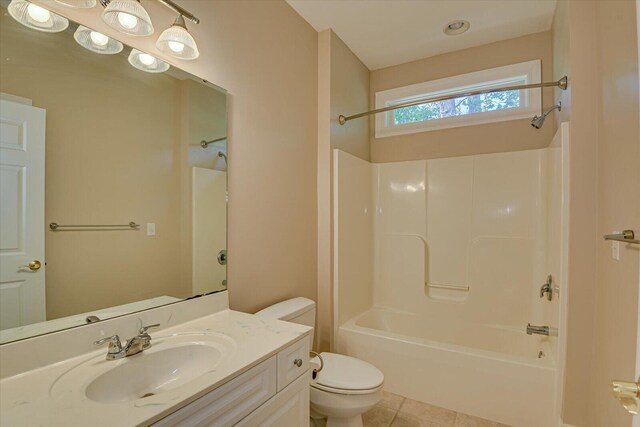 full bathroom with bathing tub / shower combination, tile patterned flooring, vanity, and toilet