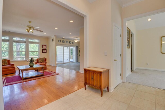 interior space with crown molding and light tile patterned floors