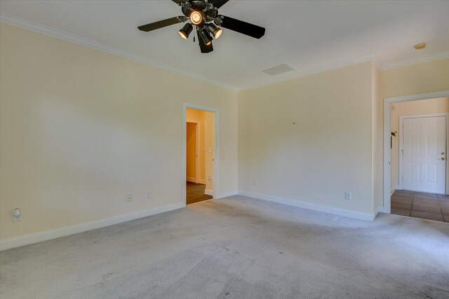 carpeted spare room featuring ceiling fan and ornamental molding