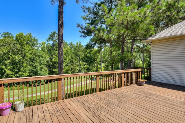 wooden terrace featuring a yard