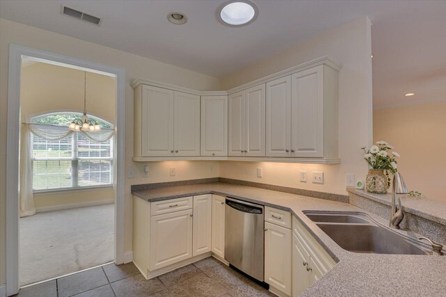 kitchen featuring dishwasher, white cabinets, a notable chandelier, and sink