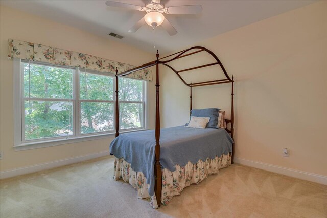 bedroom with ceiling fan and light colored carpet