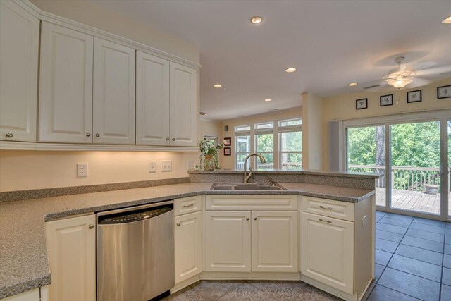 kitchen with kitchen peninsula, dishwasher, white cabinets, and sink