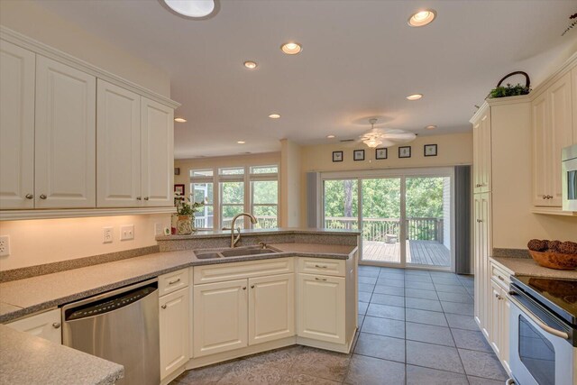 kitchen featuring white cabinetry, sink, ceiling fan, kitchen peninsula, and appliances with stainless steel finishes