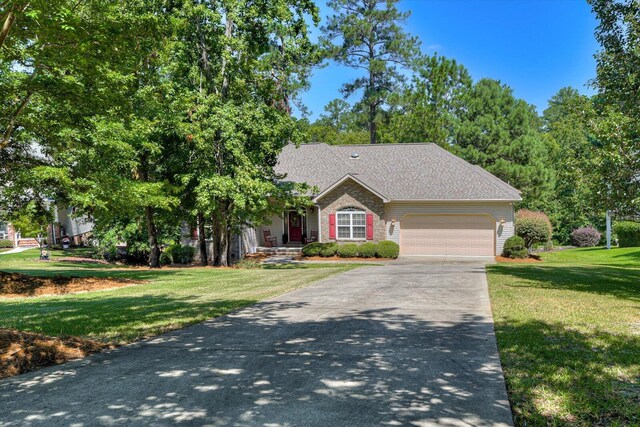 view of front of home featuring a garage and a front yard