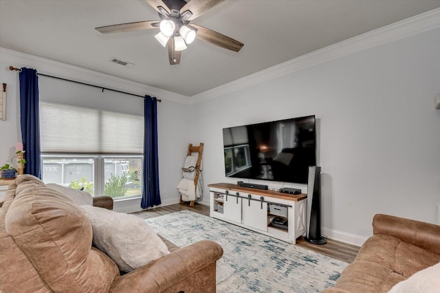 living room featuring hardwood / wood-style flooring, ceiling fan, and ornamental molding