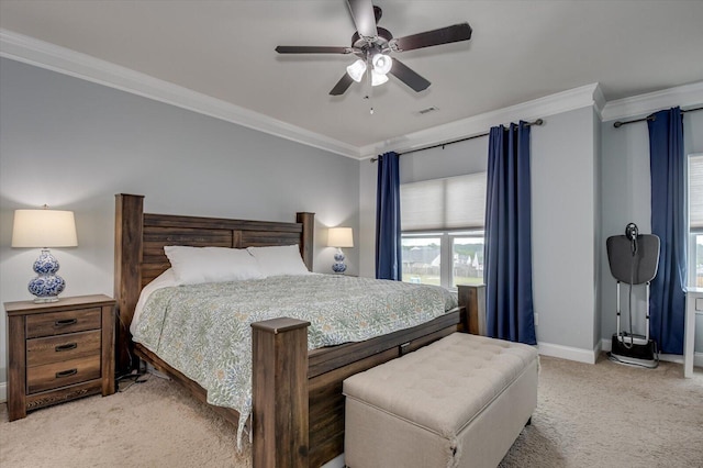 carpeted bedroom with ceiling fan and ornamental molding