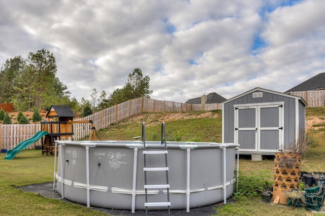 view of pool featuring a playground and a lawn