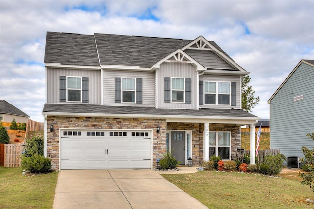 craftsman inspired home featuring a garage, central air condition unit, and a front yard