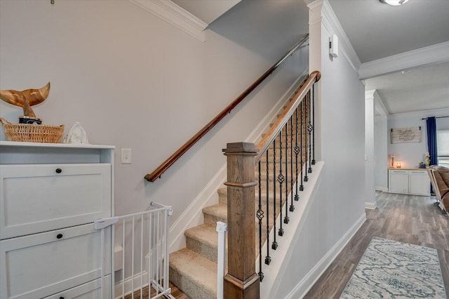 stairs with crown molding and hardwood / wood-style flooring