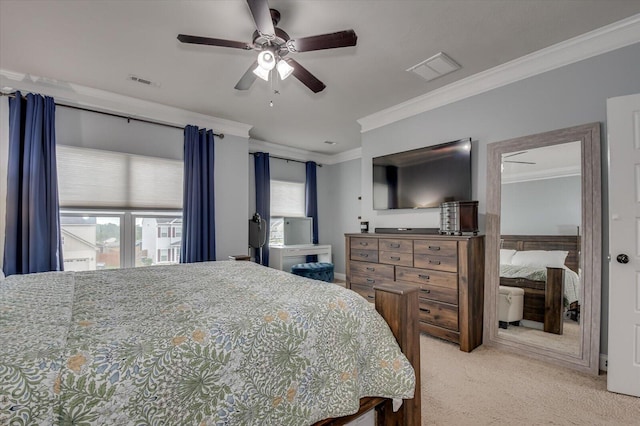 carpeted bedroom with ceiling fan and ornamental molding