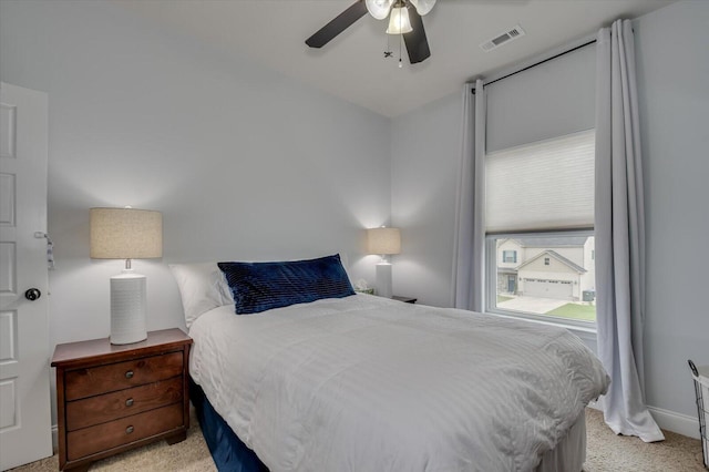 bedroom featuring light carpet and ceiling fan