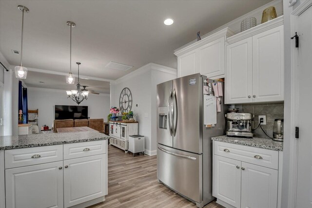 kitchen featuring pendant lighting, backsplash, an inviting chandelier, white cabinets, and stainless steel fridge with ice dispenser