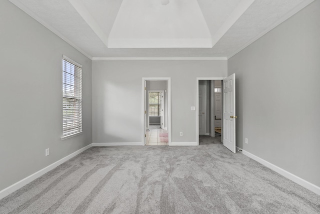 1629 Jamestown Ave, Evans, GA 30809 - unfurnished bedroom with carpet floors, a tray ceiling, crown molding, and baseboards