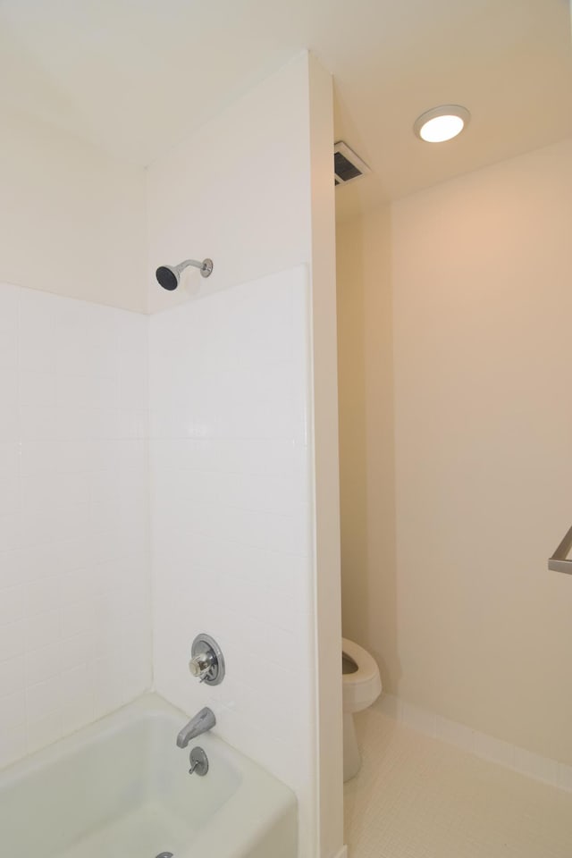 bathroom featuring tile patterned floors, shower / tub combination, and toilet