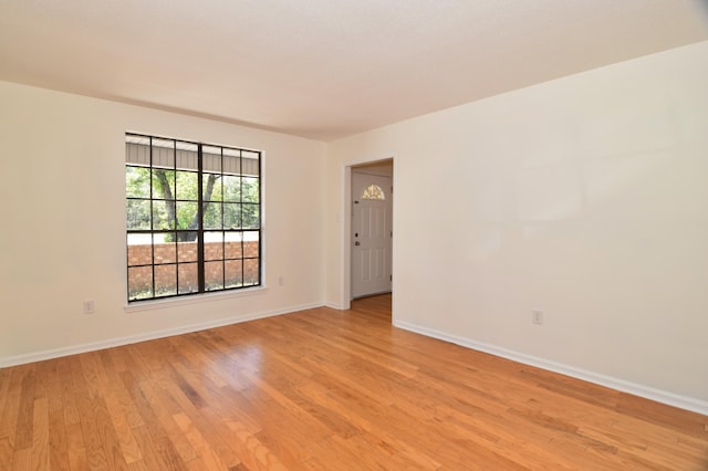 spare room with light wood-type flooring