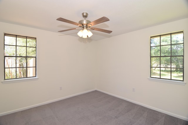 carpeted spare room with ceiling fan