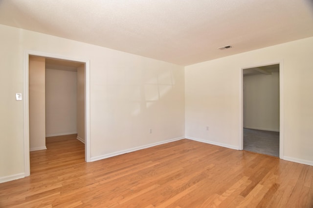 spare room with light wood-type flooring