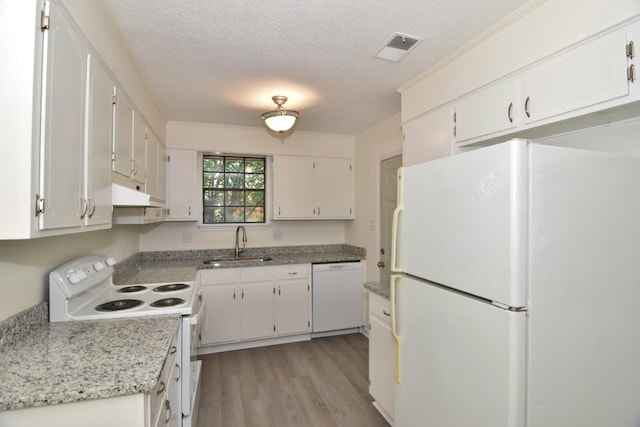 kitchen with white cabinets, white appliances, sink, and a textured ceiling