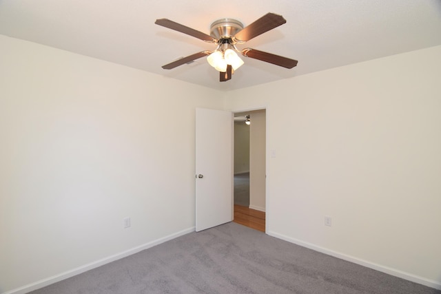 empty room featuring light carpet and ceiling fan