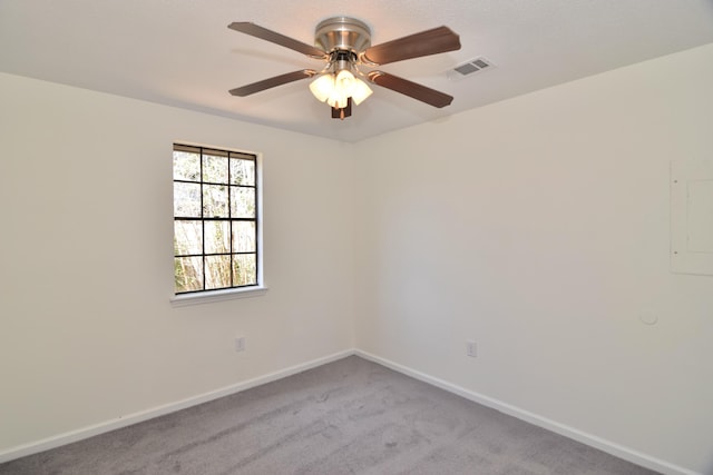 carpeted empty room featuring ceiling fan