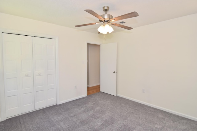 unfurnished bedroom featuring ceiling fan, carpet floors, and a closet